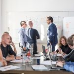 Group of happy people working in a conference room.