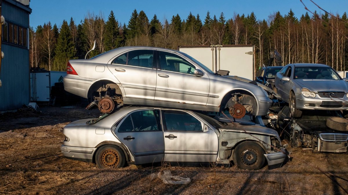 Wrecked cars on a field.