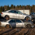 Wrecked cars on a field.