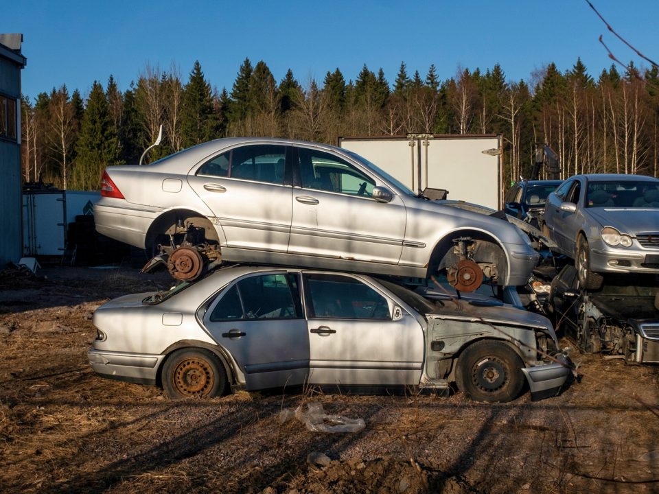 Wrecked cars on a field.