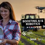 Young female farmer on a field flying a drone.