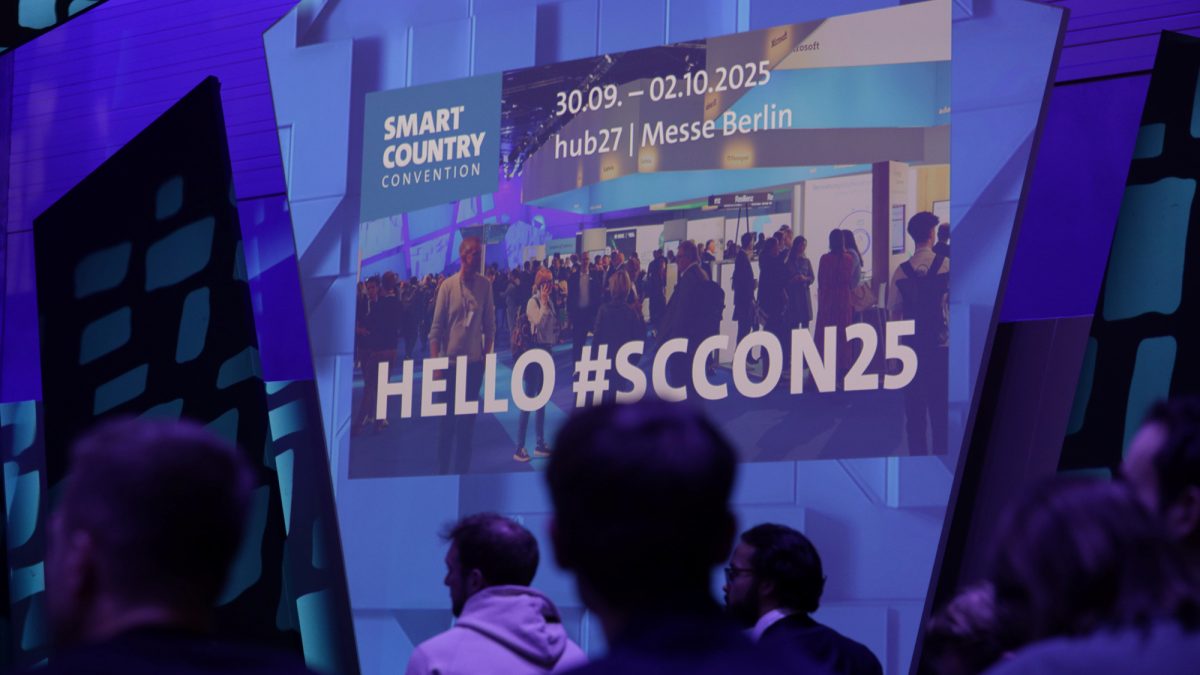 Convention hall full of people and a sign reading Hello #SCCON25.