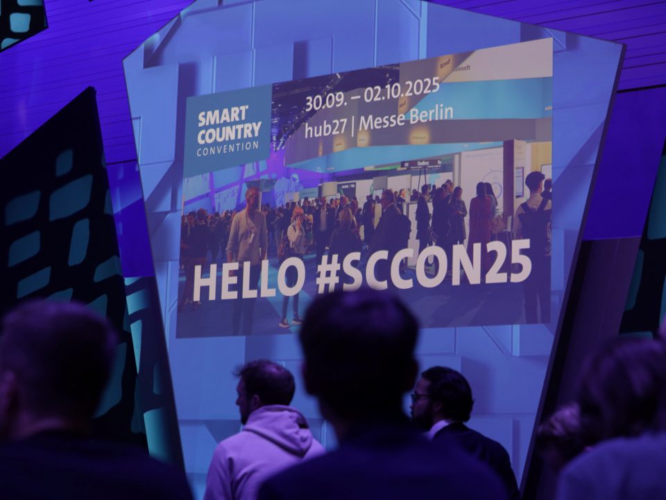 Convention hall full of people and a sign reading Hello #SCCON25.