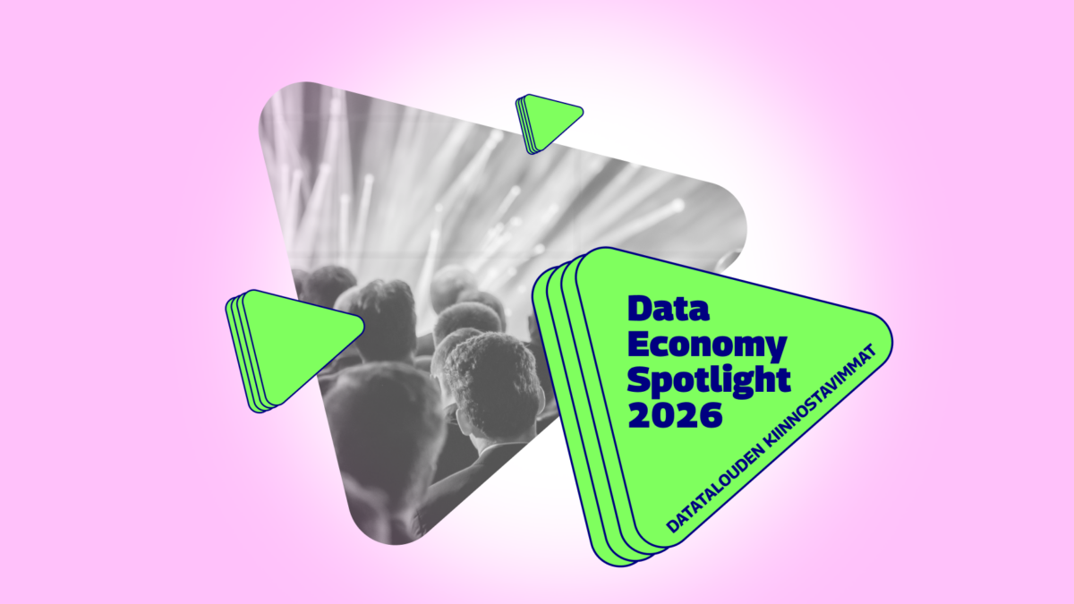 Graphic with a pink background featuring a triangular black‑and‑white photo of an audience looking toward a bright stage. Next to it is a green triangular shape with dark blue text reading 'Data Economy Spotlight 2026' and smaller text 'Datatalouden kiinnostavimmat'. Several smaller green triangular graphic elements surround the main shapes.