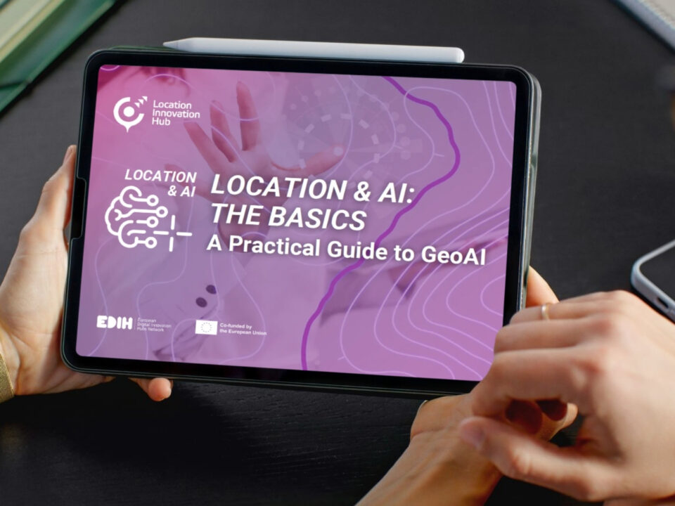 Person holding a tablet displaying the GeoAI guide “Location & AI: The Basics”.